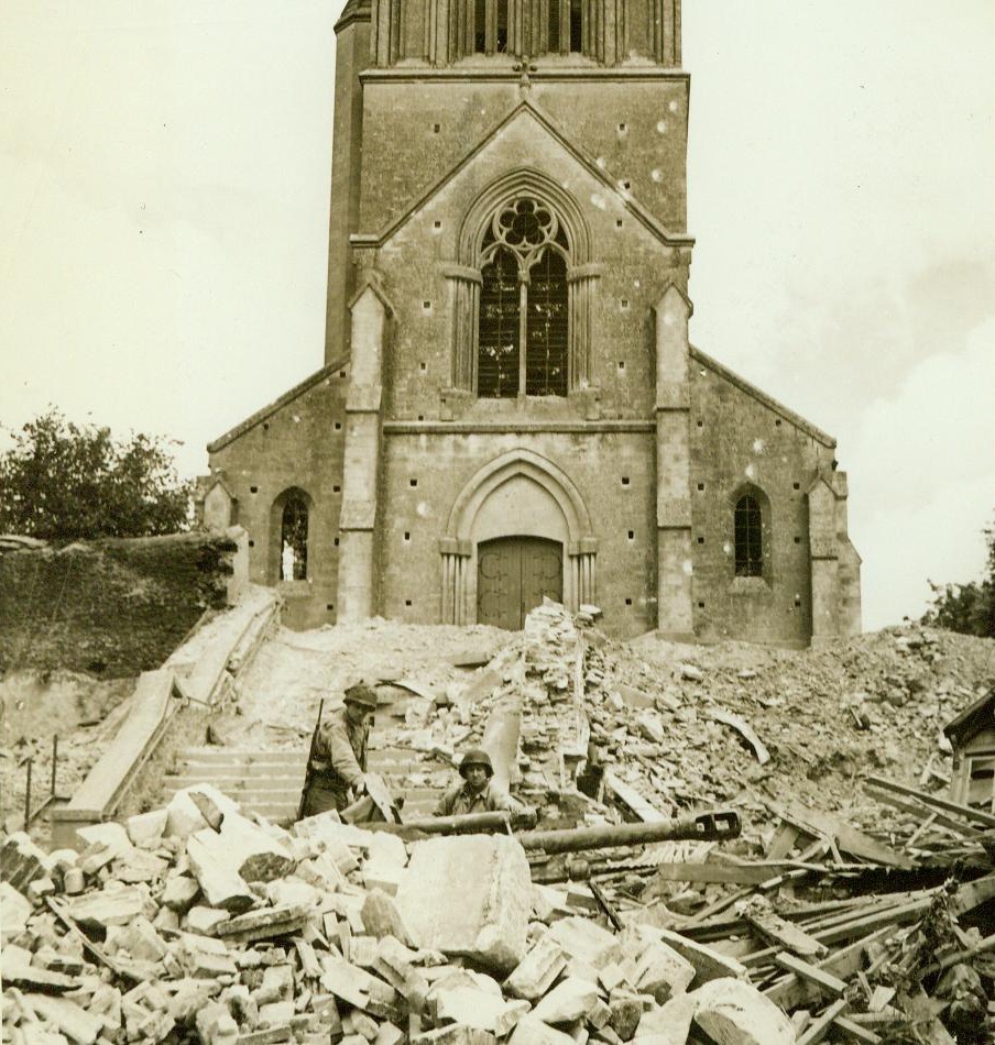 Church Is Haven For German Gun, 8/2/1944. Marigny, France – Pvt. Lowell E. Reau, Green Bay, Wisc. (left), and Cpl. Joseph Rombage, New York City, examine a knocked out German gun which they found amid the ruins of its emplacement outside the church in Marigny. 8/2/44 (ACME Photo By Andrew Lopez, War Pool Correspondent);