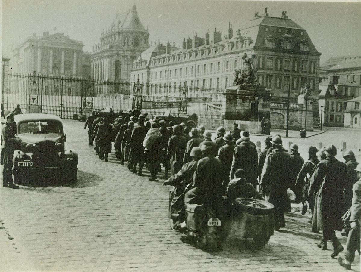 Allies Strike to Free Paris, 8/7/1944. PARIS, FRANCE -- Nazis in Paris march French prisoners past the Palace of Versailles where the Treaty, which the Germans say was the cause of the war, was signed. After four years of Nazi rule, Paris is once more a military objective as American armored columns race at terrific speed to free the French capital. EDITORS: We have prepared this art for possible use when Allied forced enter Paris. Credit: (ACME);