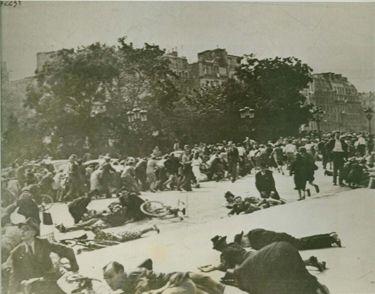 Hugging the Streets for Safety, 8/28/1944. PARIS -- Keeping their heads during the panic that ensued when German snipers fired into crowds outside Notre Dame Cathedral, Parisians stretch out on the pavement for safety. In the background, scores of frightened civilians run through the street. This is a British War Office Photo. Credit: (Army Radiotelephoto from ACME);