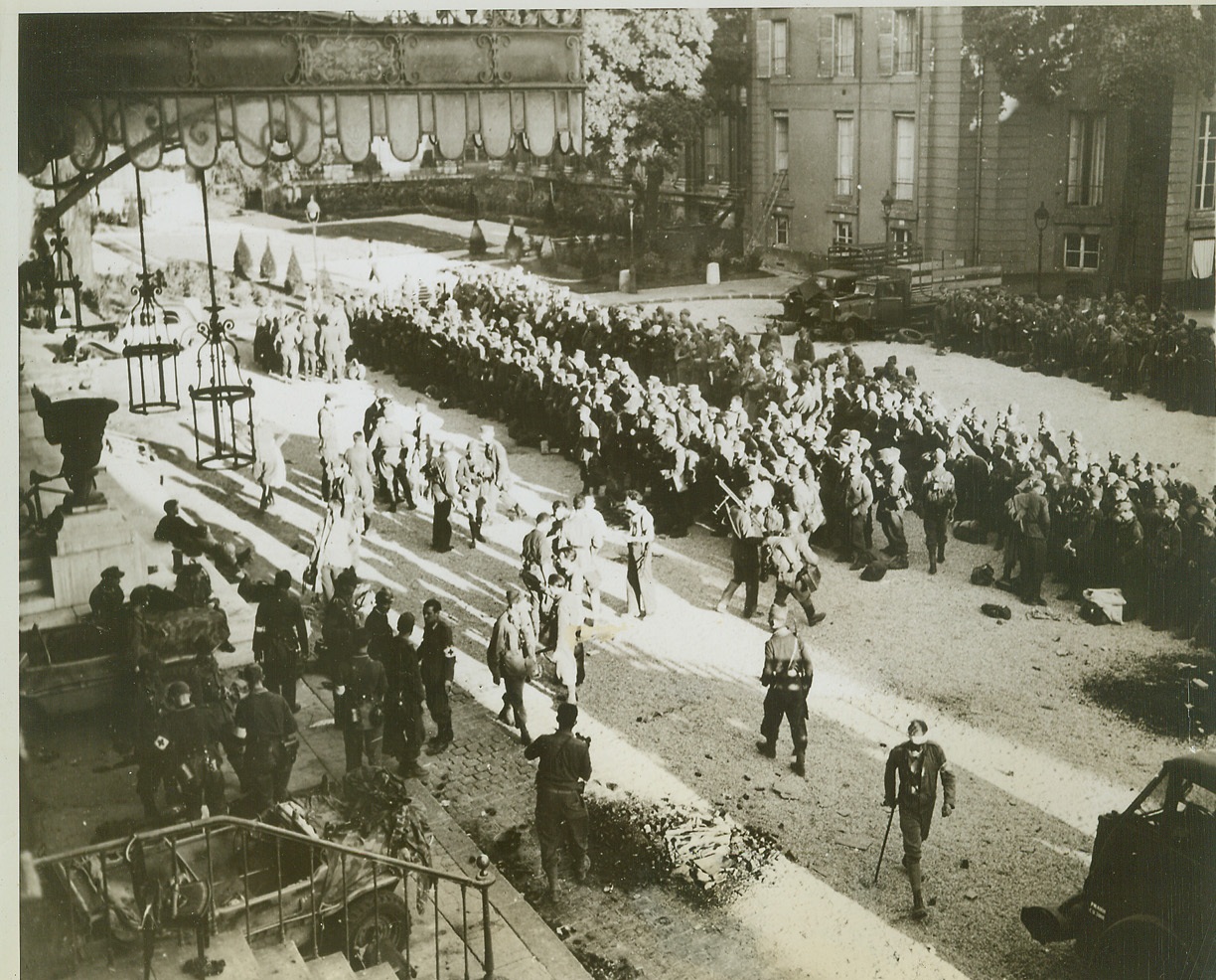 France Regains Its Chamber of Deputies, 8/30/1944. France—Some of the 400 Germans who barricaded themselves in the Chamber of Deputies in Paris and fought off liberating troops are lined up in the courtyard after surrending to French partisan forces.  Credit: ACME;