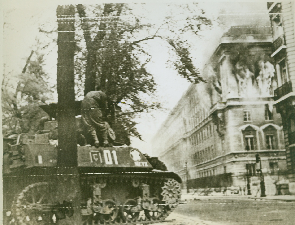 Chamber of Deputies Burns, 8/28/1944. Paris—Flames and smoke pour from the windows of the Chamber of Deputies in Paris, which was used as a defense point by German troops and French fascists. A free French tank halts in the street below. Credit: ACME photo via Army radiotelephoto;