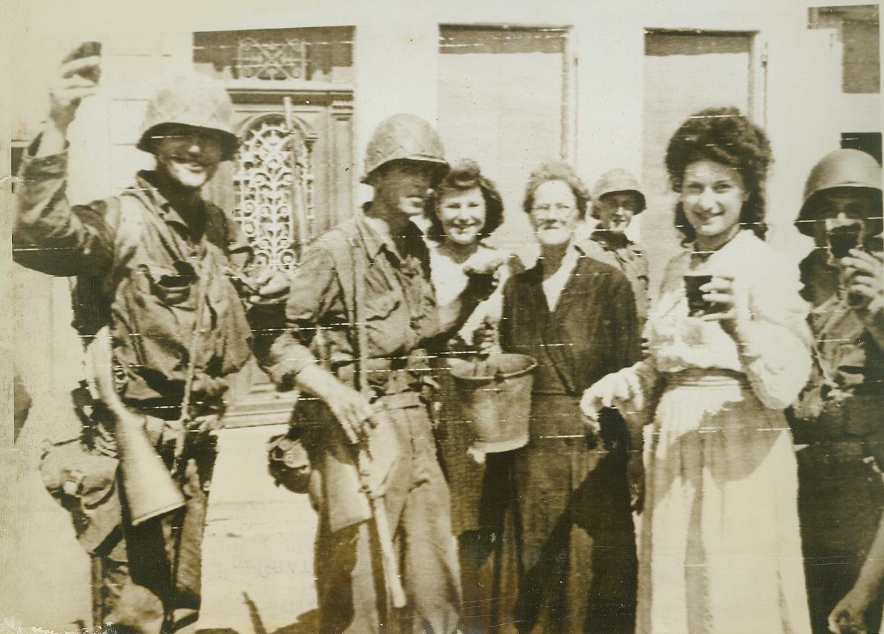 Wine "Bucket Brigade", 8/17/1944. France—Grateful natives of this town in Normandy bring wine in buckets to refresh Yank liberators passing through the streets.  Credit: Army radiotelephoto from ACME;