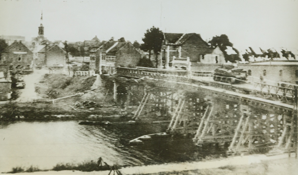 Allies Advance in Belgium, 9/13/1944. BELGIUM—British armored vehicles roll across the Albert Canal at Beeringen in Belgium. Original bridge was destroyed by Nazi demolition squads but was rebuilt by Allied engineers to allow troops to advance. Credit: ARMY RADIOTELEPHOTO FROM ACME.;