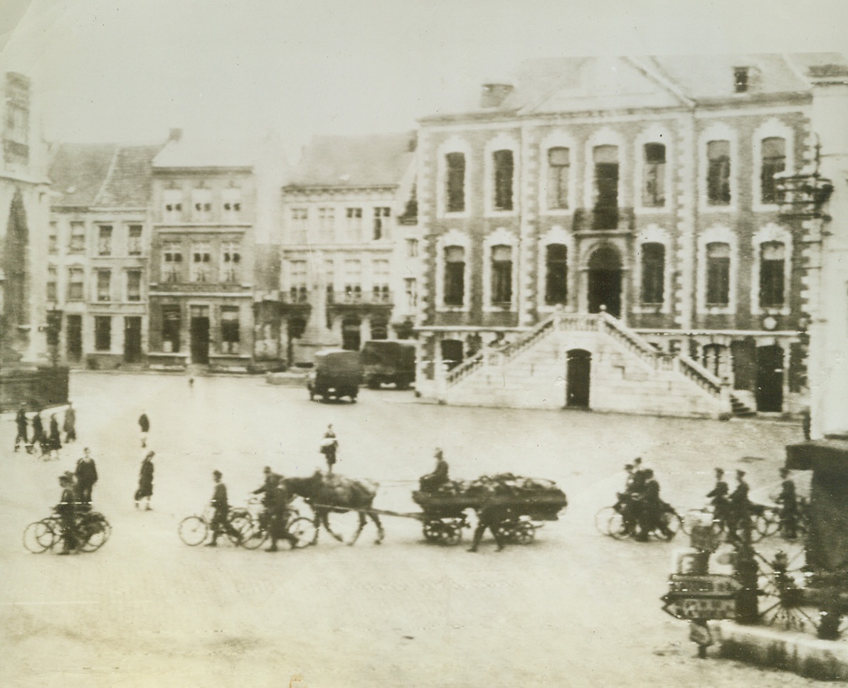 Sneaking Out, 9/15/1944. BELGIUM—Moving in horse drawn carts and pushing their bicycles, the Nazis evacuate Belgium in a far different manner from that in which they entered so triumphantly several years ago. This photo was taken secretly by a Belgian Civilian before the Allies arrived. Credit: SIGNAL CORPS RADIOTELEPHOTO FROM ACME.;