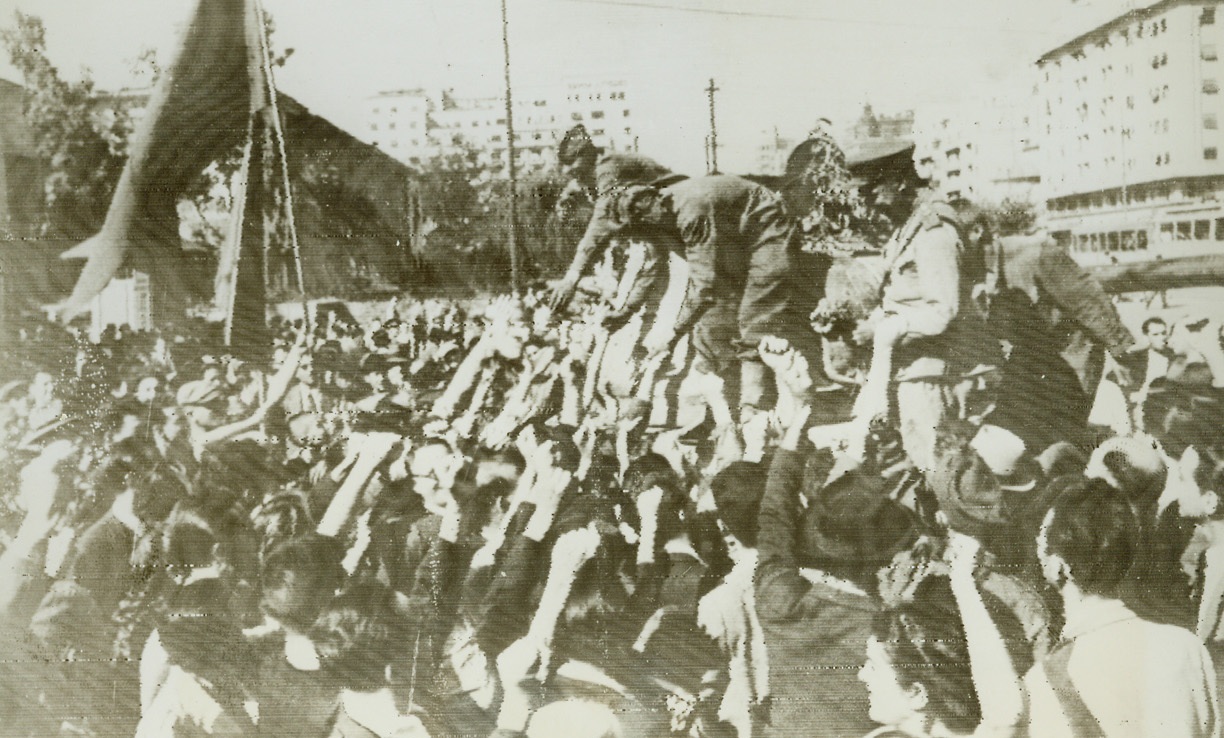 Bucharest Welcomes Red Forces, 9/2/1944. BUCHAREST, ROMANIA – As the Red Army enters the Romanian capital of Bucharest, people crowd the streets and reach out eager hands to grasp those of their liberators. Russian forces, fresh from the capture of Bucharest, are driving on the Bulgarian border on the Danube, and have captured Giurgiu, headquarters of commerce between Romania and Bulgaria. Credit (ACME Radiophoto);