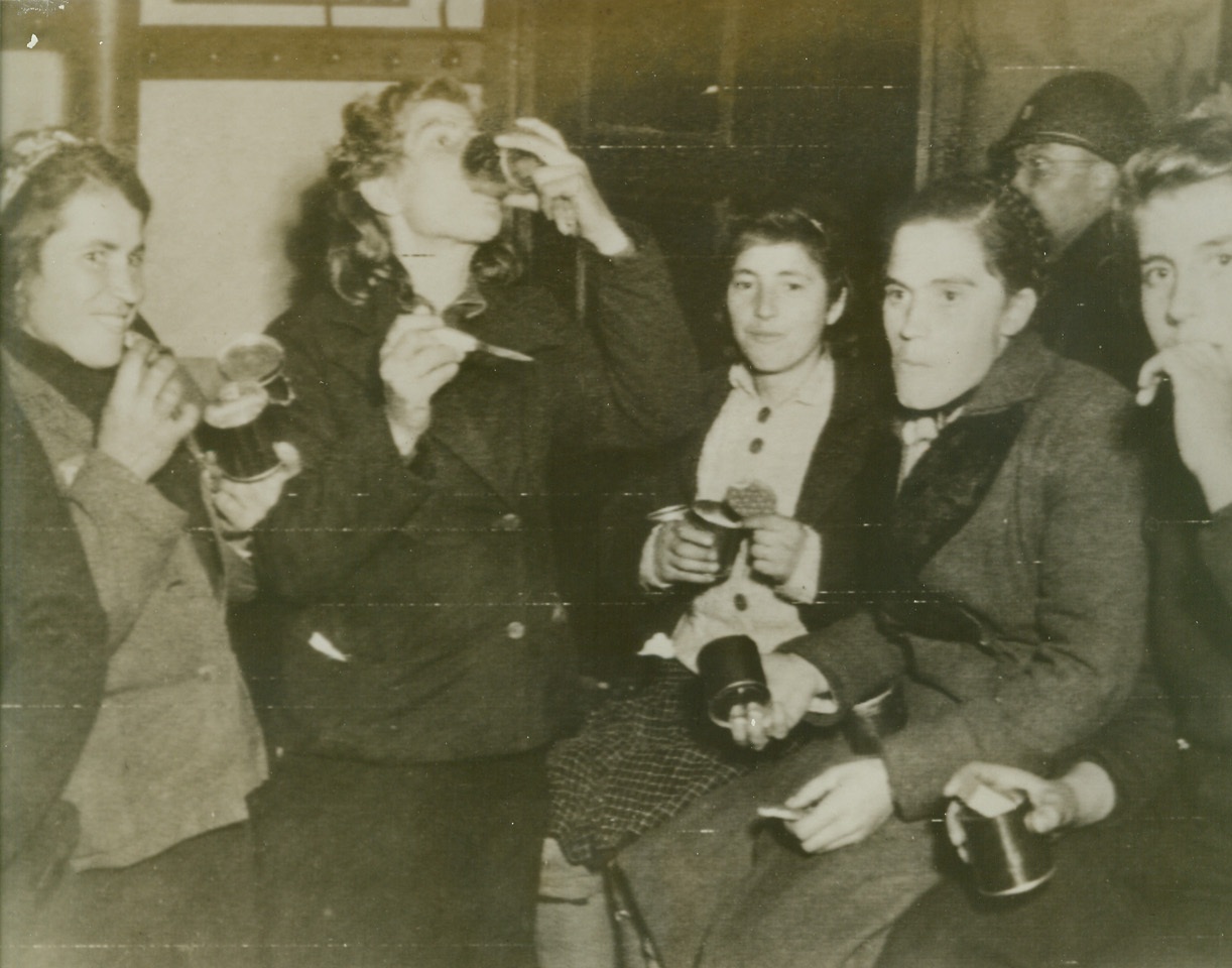 ARMY CHOW FOR GERMAN REFUGEES, 9/28/1944. Refugees from inside Nazi-dominated sectors, sample U.S. Army rations at a depot set up for them by the Allied Military Government. Credit: Army radiotelephoto from Acme;