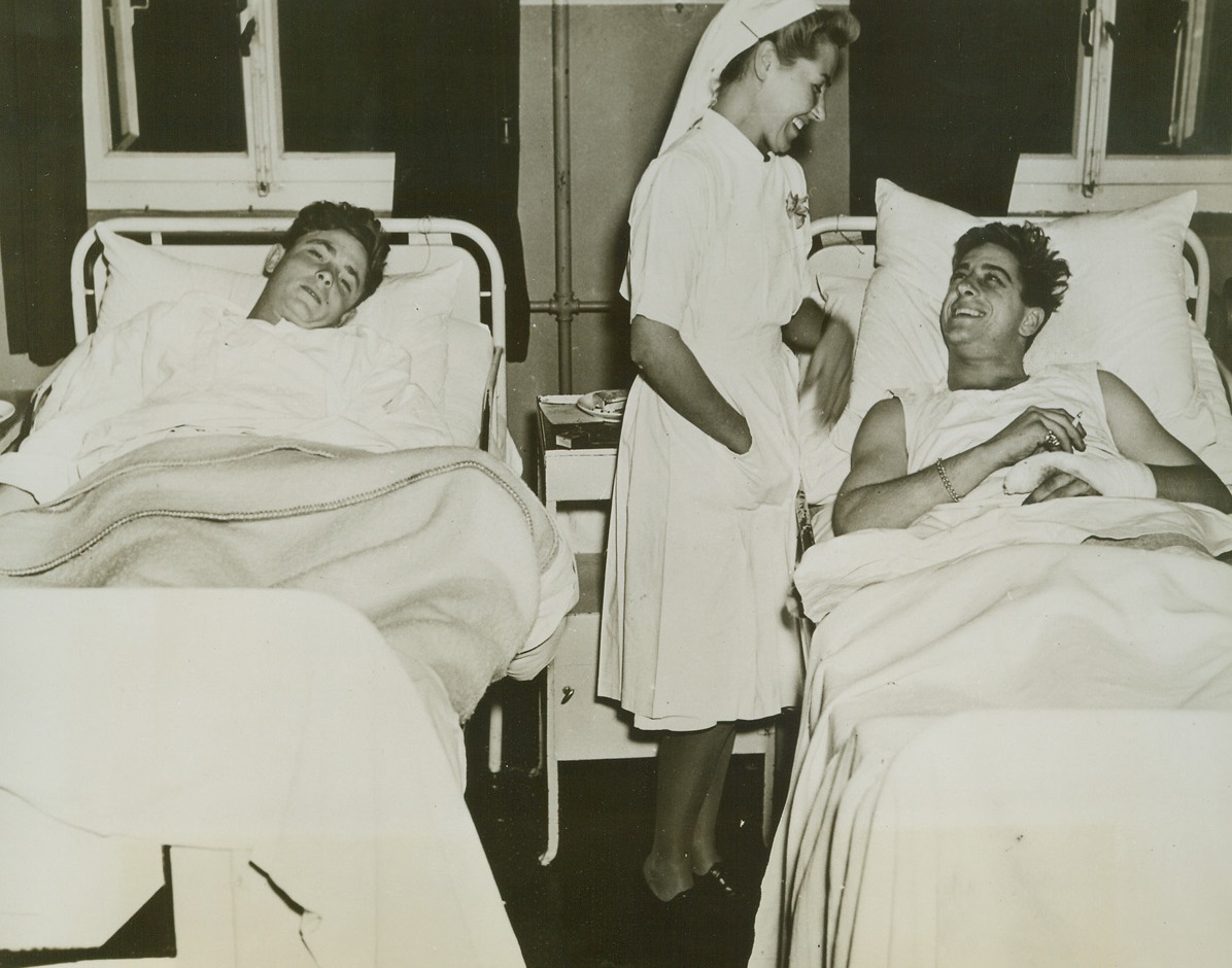 Cheer from a Dutch Nurse, 9/27/1944. Two American paratroopers, casualties in the recent airborne assault on the German lines in Holland, are cheered up by a pretty, blonde Dutch nurse in a civilian hospital at Nijmegen. Credit: Signal Corps photo from ACME;