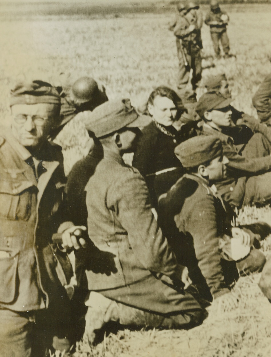 NAZIS AND GIRL FRIENDS PRISONERS, 9/8/1944. FRANCE—Taken prisoner by the small American force which captured the French city of Mons, Nazis and the women found with them are herded into a prison compound. Credit (Army Radiotelephoto from ACME);