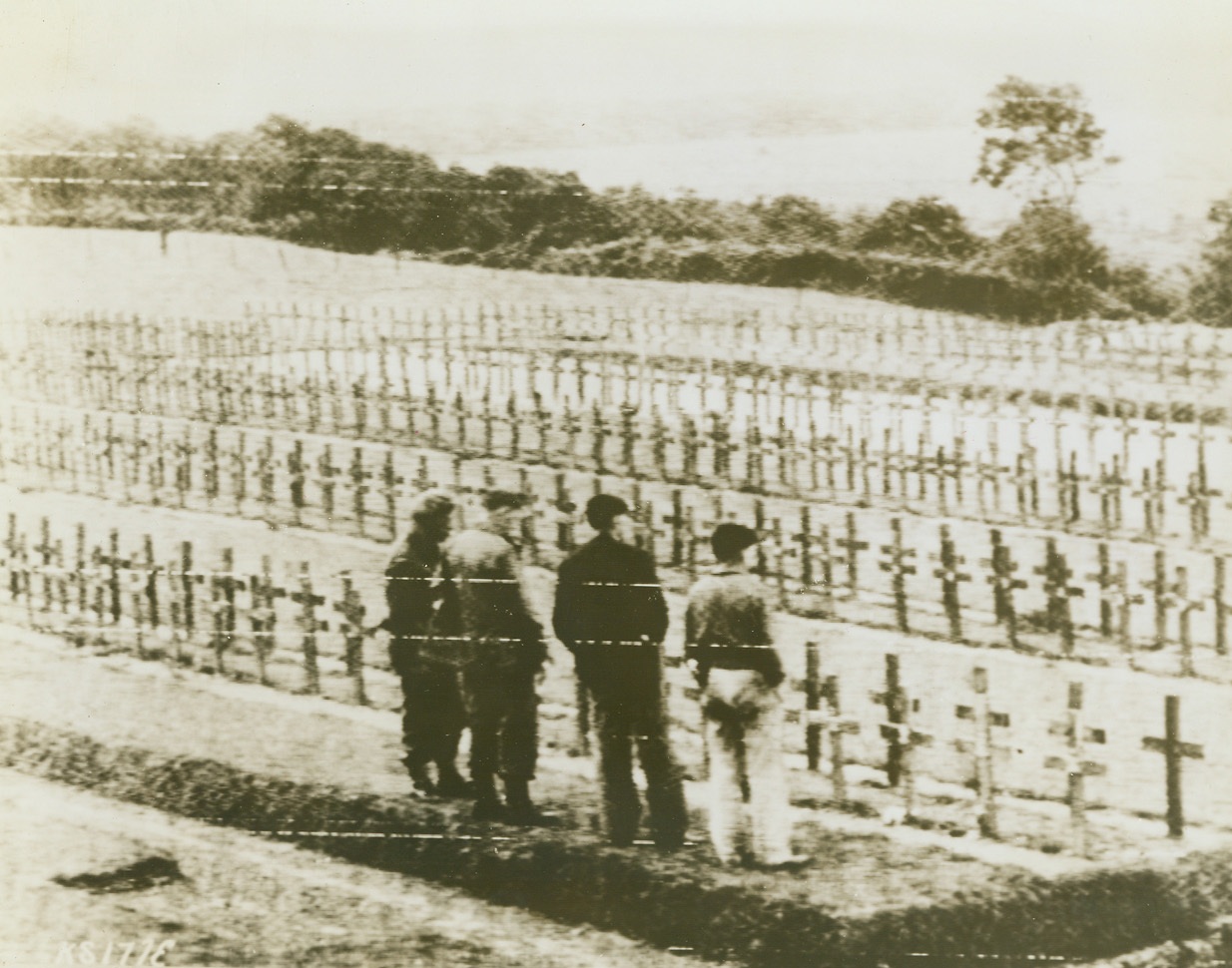 Tribute to Dieppe Raiders, 9/3/1944. Dieppe – Two Canadian soldiers and two Frenchmen visit this crowded cemetery at Dieppe to pay their respects to fallen British and Canadian heroes who died in the famous Commando raid of August, 1942. Credit: Army Radiotelephoto from ACME;