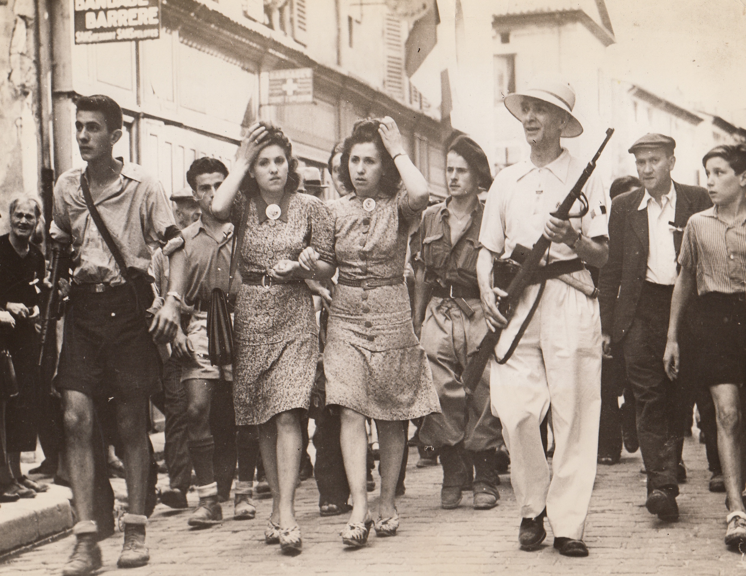 Fix Hair For Last Time, 9/14/1944. France – Two French collaborationists, being marched to prison in Montelimar, France, adjust their hair for the last time before paying the price for befriending the Nazis. Girls will have their locks shorn from their heads 9/14/44 Credit (Signal Corps Photo From ACME);