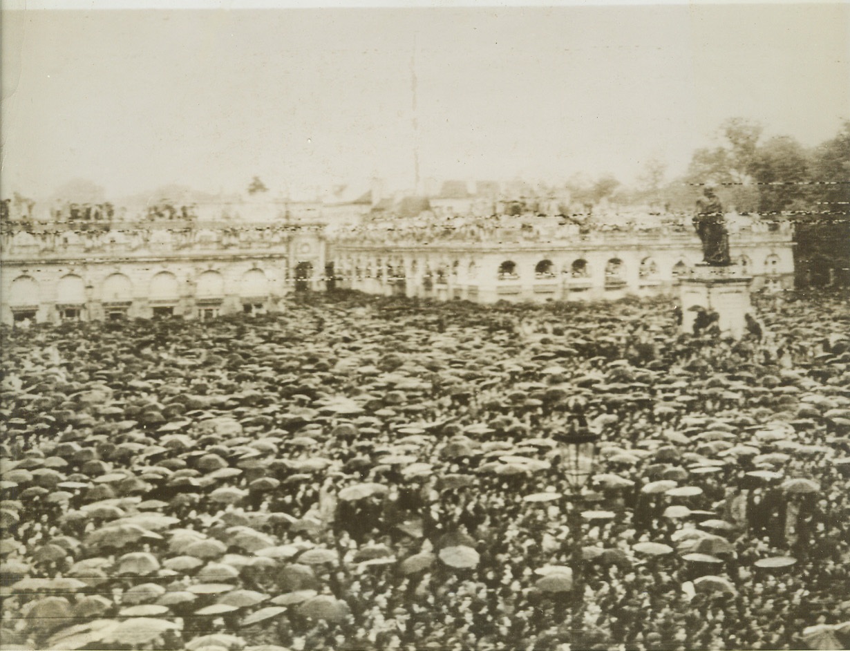 No Dampening Their Spirits, 9/29/1944. Nancy, France—This huge mass of umbrellas and heads is only a small part of the crowd that jammed the Place Stanislas in Nancy, awaiting the arrival of Gen. de Gaulle. The leader of the French forces of liberation addressed members of the French armed forces and civilians here. Credit: Signal Corps radiotelephoto from ACME;