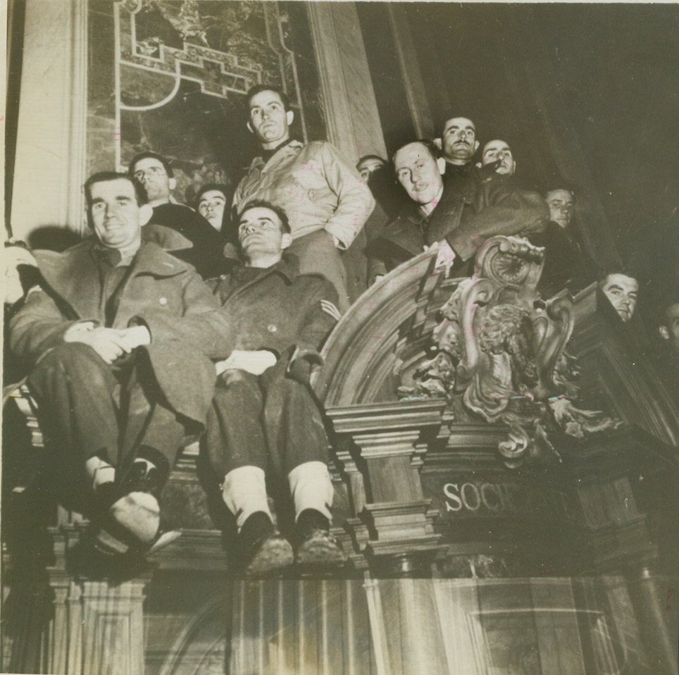 GI's At Midnight Mass in Rome, 1/6/1945. ROME -- American soldiers find a point of vantage as they attended midnight mass services, Christmas Eve, in St. Peters. Pope Pius officiated. Credit-WP-(ACME);