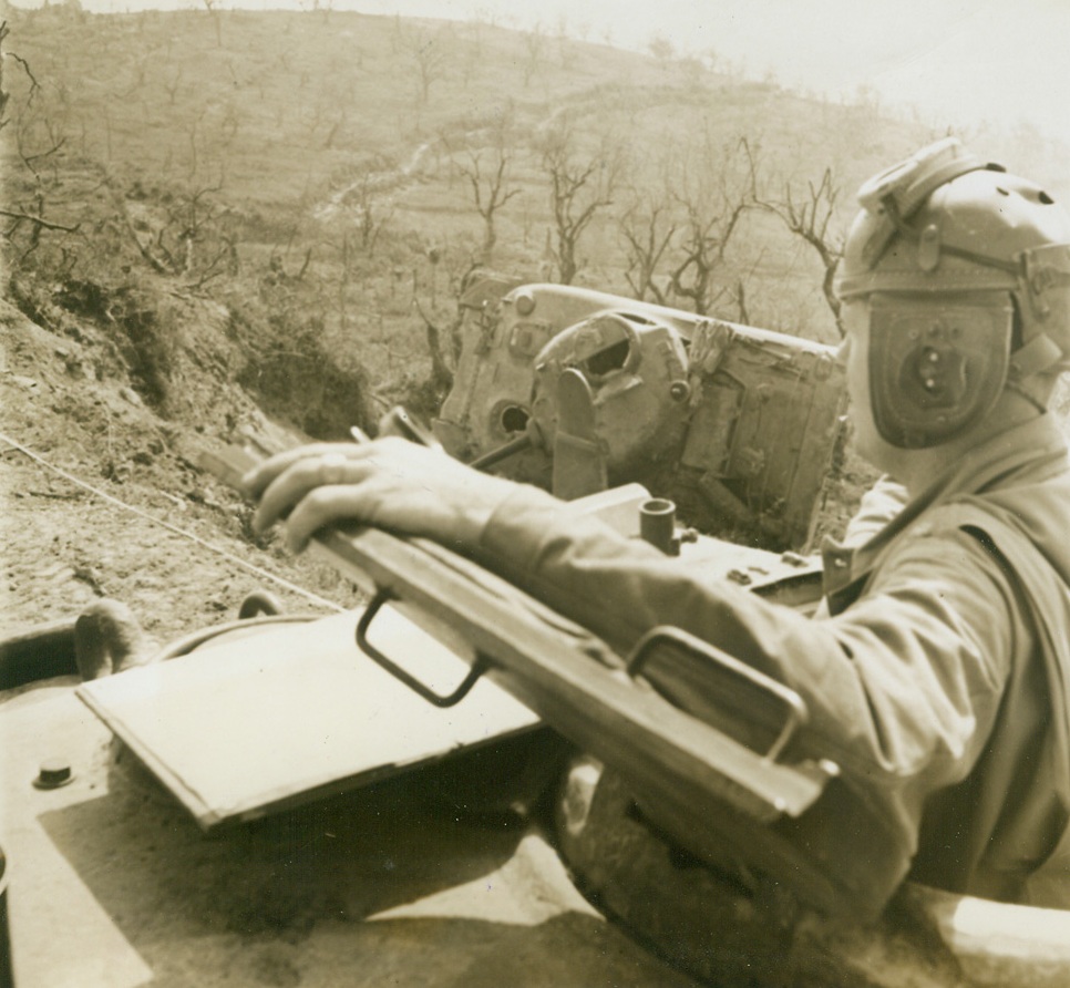 TEXAN LEADS TANKS IN ITALY. Maj. Andrew R. Cheek, of Stockdale, Tex., Battalion Commander of a U.S. tank out-fit, leads his tanks into the Battle of Santa Maria Infante, Italy, which was later captured. A knocked out tank can be seen at right.;