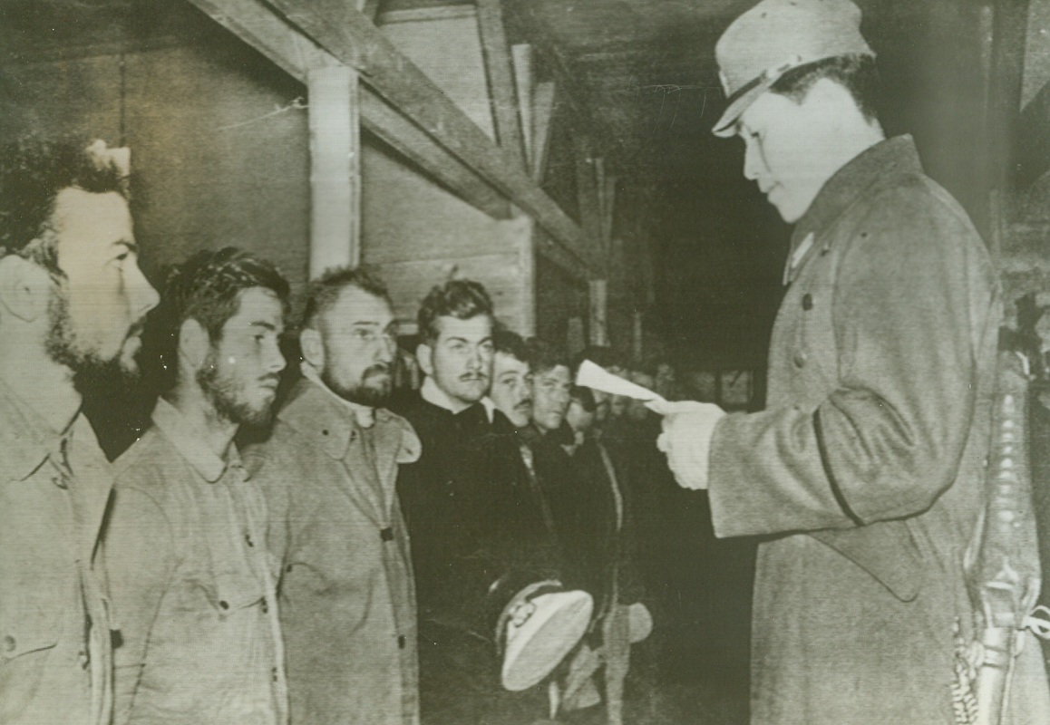 No Title. Reproduced from English-Language propaganda magazine “Freedom” published by Japs at Shanghai to give their version of internment of U.S. subjects pending their exchange. Caption describes this pix as Lieut. Matsuda of Japanese Military Press Bureau advising internees of British defeat at Singapore.;