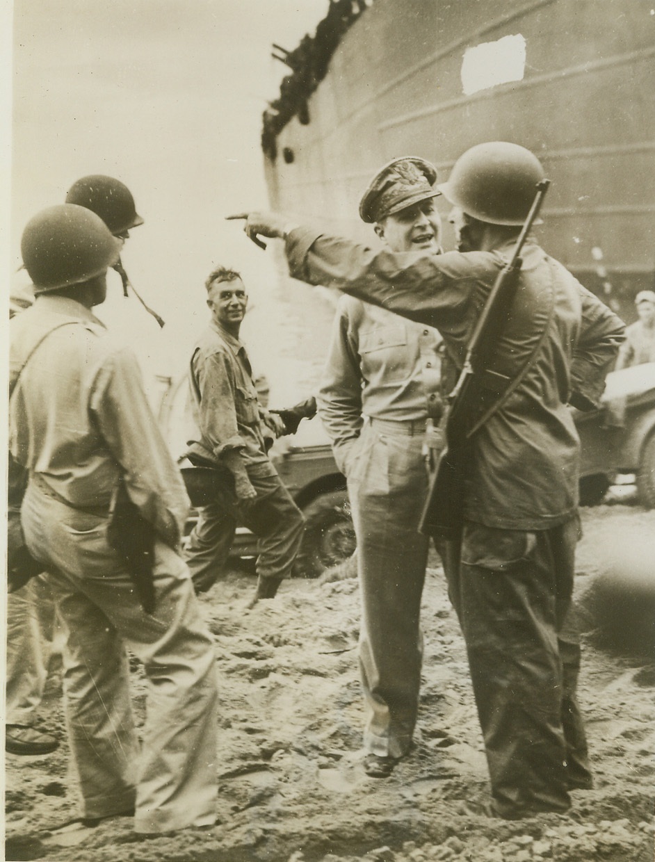 MacArthur on the Spot. DUTCH NEW GUINEA -- Less than two hours after his American and Australian troops stormed ashore at Taoji, only 1800 yards from Hollandia Airport, Dutch New Guinea, Gen. Douglas MacArthur joined his men on the jungle beach. Here he gets the latest ... from a beachhead officer. Disdaining... danger, he went ashore without ...(pausing)...to wear a steel helmet. Credit: (ACME);