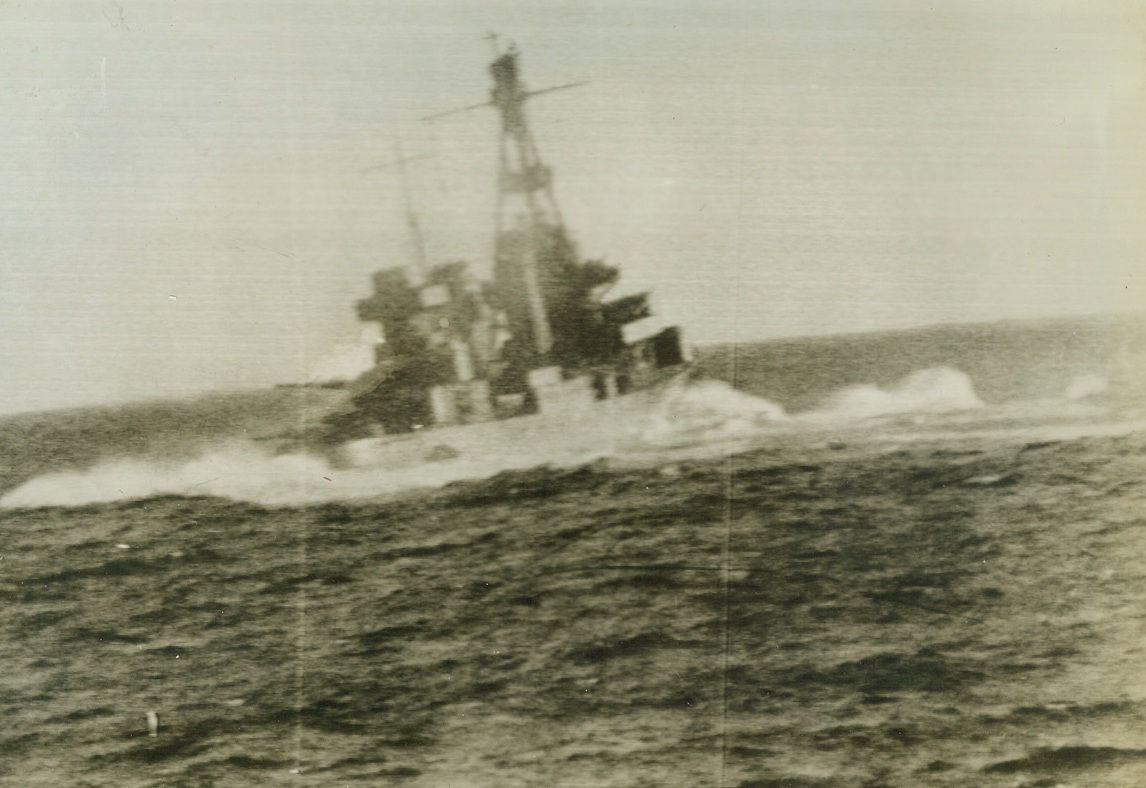 No Title. A United States war ship does a quick turnabout to avoid the death load of a Japanese bomber overhead during attack Marshall & Gilbert Islands.  One of first photos bombardment Marshall-Gilbert islands.   ACME from Pathe news;