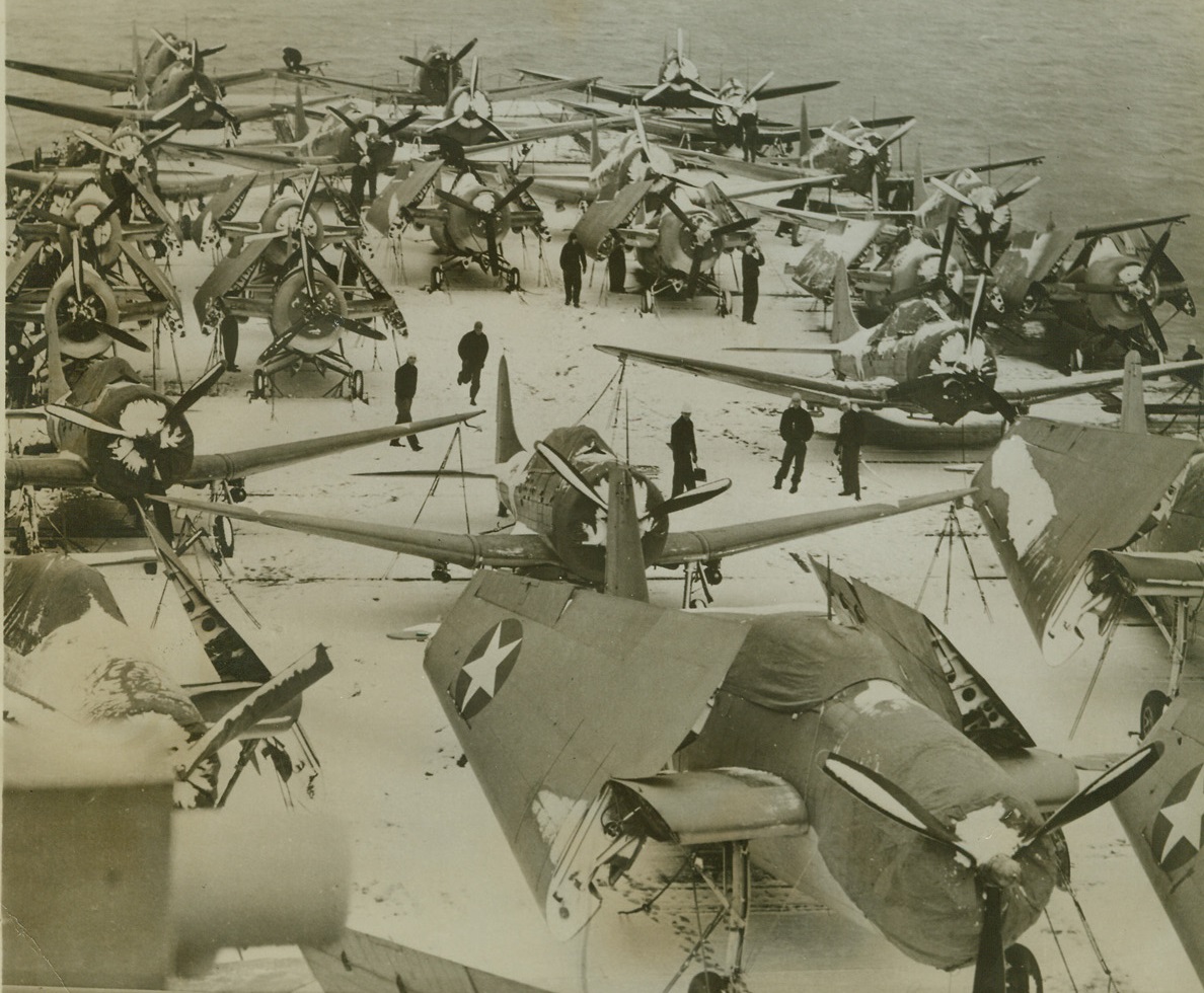 War Birds in the Snow. A North Atlantic Port -- Douglas Dauntless Dive Bombers and Grumman Avenger Torpedo Planes are shown tied down on the snow-covered flight deck of a U.S. Navy aircraft carrier in this photo taken at “a North Atlantic port” recently. Credit: U.S. Navy photo from ACME;