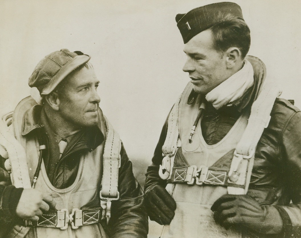 Oldest And Toughest. England – The oldest air gunner in the European theatre of Operations, S/Sgt. David Cole (Left) is also one of the toughest men in our Air Force. Formerly a taxi driver of Portland, Ohio, he is 43 years old and a veteran of the First World War. He is shown talking to the pilot of his Fortress, 1st Lt. Jack Fowles, 20, of San Jose, California.;