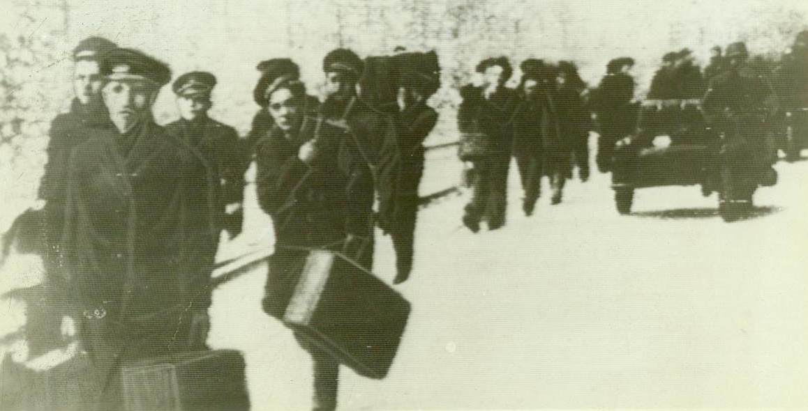 No Title. Toulon, France: After scuttling their fleet in Toulon harbor, French sailors are marched away to German concentration camps. Note German troops on motor cycles at the right of marching column;