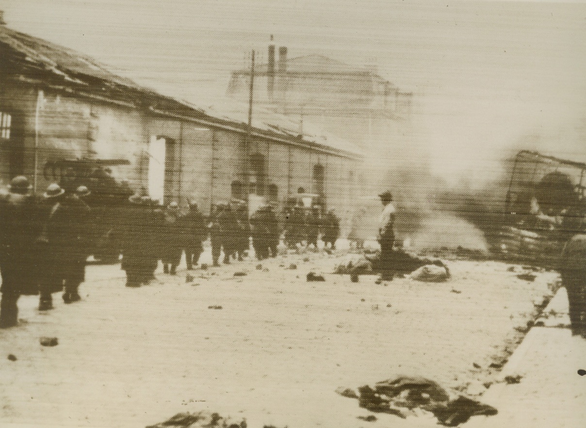 British Leaving Dunkerque in Hail of Fire, 6/5/1940  DUNKERQUE, FRANCE – The last contingent of British Expeditionary Force Troops to leave the Flanders battlefields, are shown going through Dunkerque to their embarkation point in the midst of the German bombardment, according to the French censored caption flashed here by radio with this picture, June 4.Credit: (ACME Radiophoto);