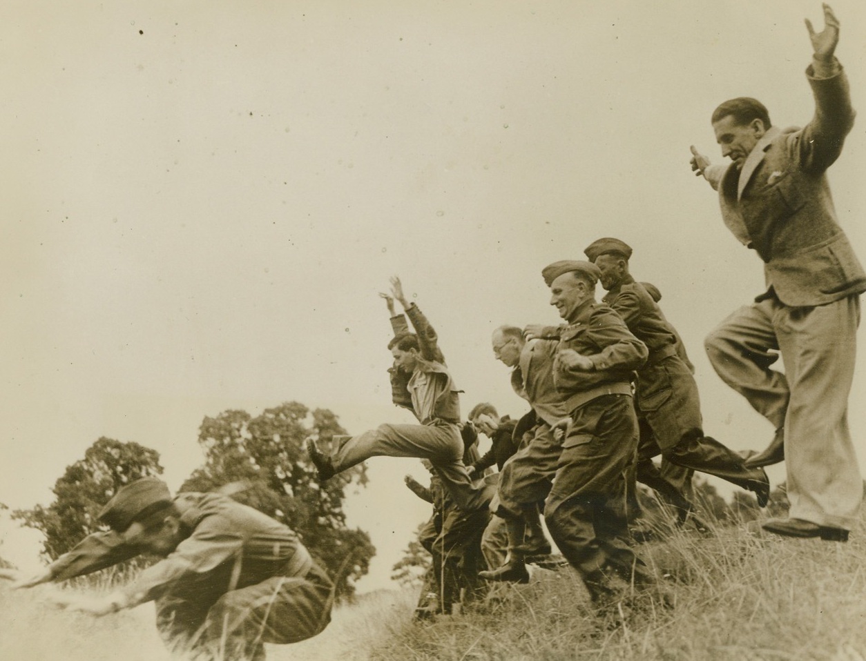 BRITAIN’S HOME GUARD STUDIES GUERRILLA WARFARE, 8/7/1940 MIDDLESEX, ENGLAND –Members of Britain’s home guard who desire instruction in Guerilla warfare tactics are taking courses at a privately run school at Osterly Park.  The courses are designed to show students how to use guile in overcoming the enemy.  All the instructors are experienced veterans.  Here a group of the students jump a ditch during training. Credit: Acme;