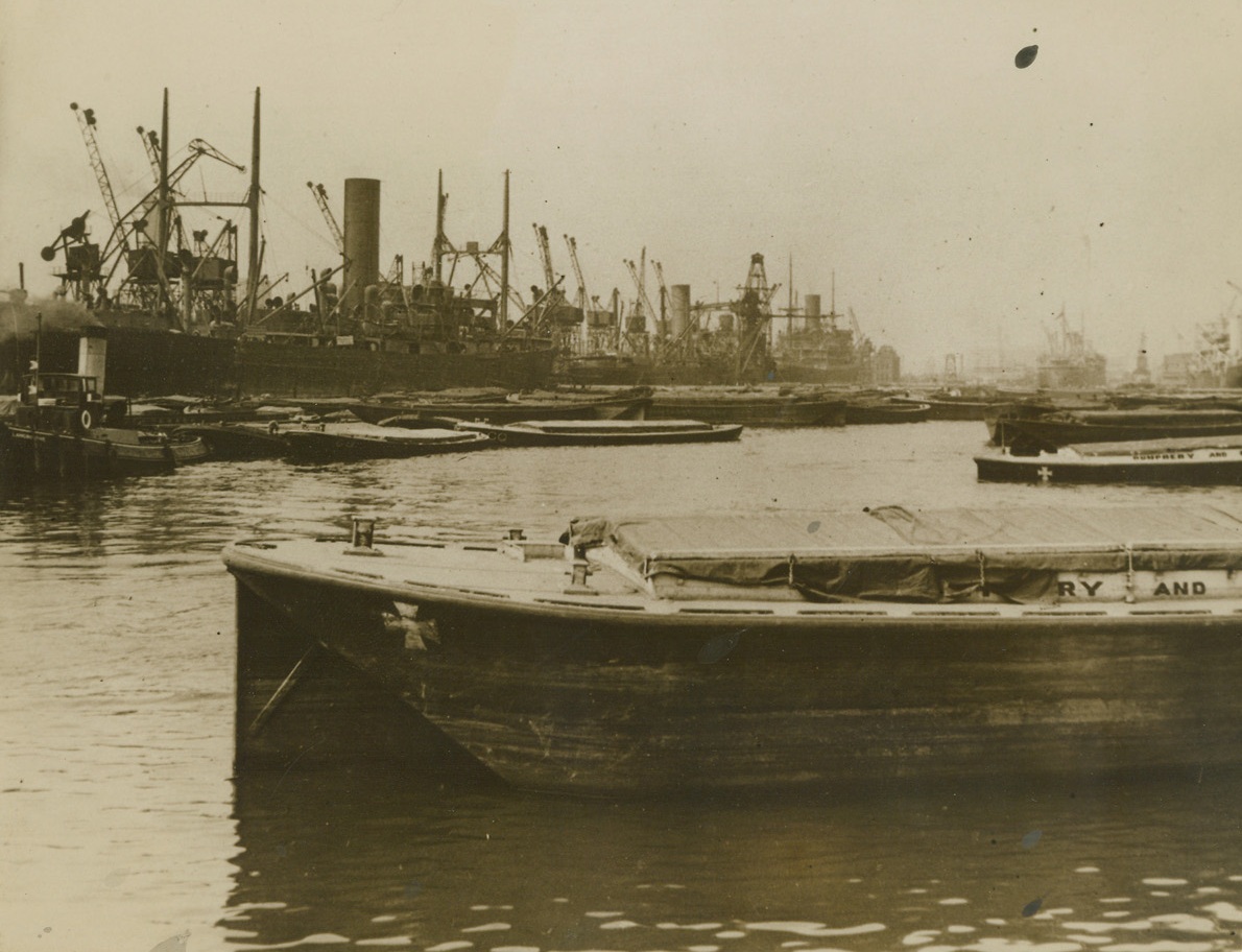 Business as Usual at Port of London, 8/31/1940  London—Denying German reports that the Port of London was put out of operation by smashing Nazi air raids, the British censor released the picture, showing ships in dock at the port, and a caption reading “Port of London a hive of industry.”  Credit: ACME.;