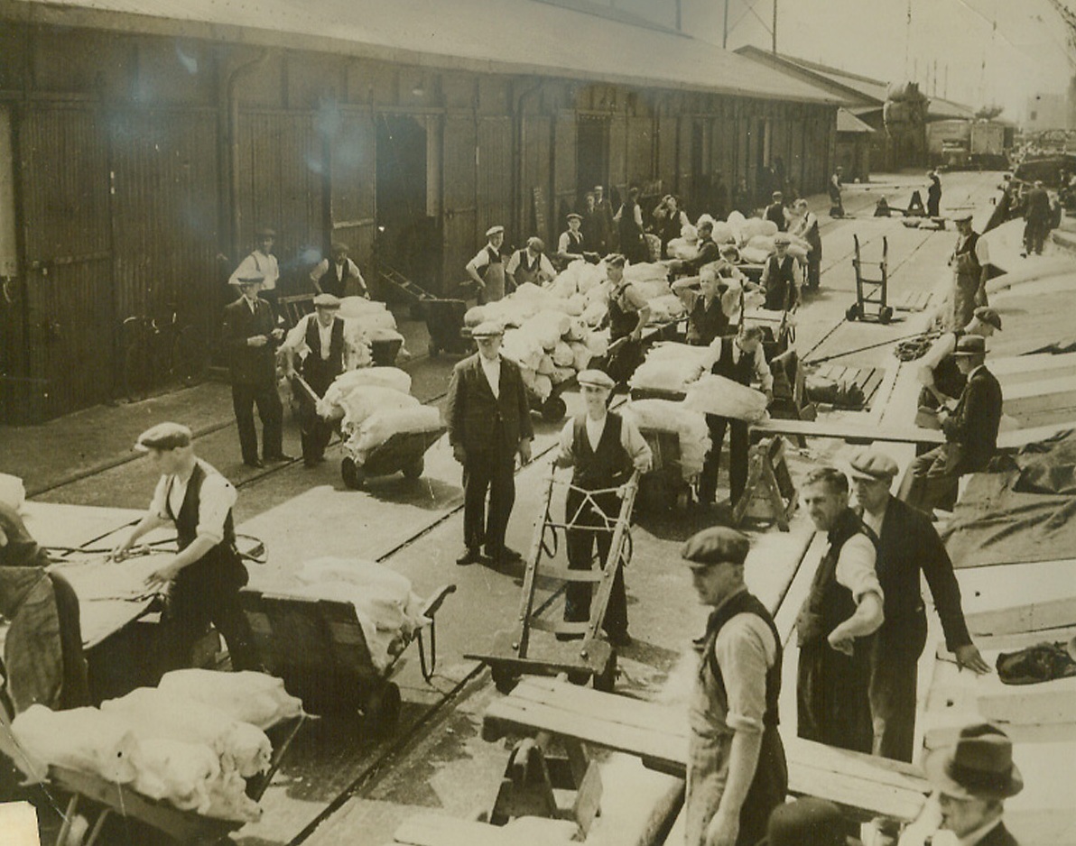 Business as Usual at Port of London, 8/31/1940  London—Denying German reports that the Port of London was put out of operation by smashing Nazi air raids, the British censor released this picture, showing meat arriving from New Zealand at the port, and a caption reading “Port of London a Hive of Industry.” Credit: ACME.;