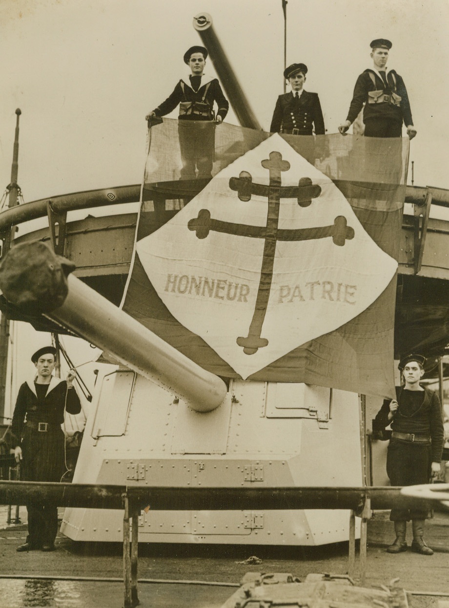 Free French Bring Destroyer To British Navy, 12/26/1940  One of the French vessels joining the English Navy under the banner of Free France after the surrender of their homeland was this Destroyer. Here Free French sailors display their flag aboard the Destroyer. Passed by British Censors. Credit: ACME;