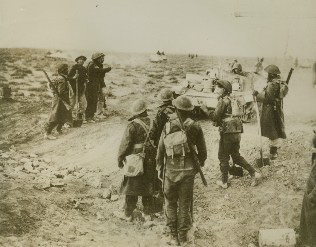 Skipping Over an Anti-Tank Ditch, 2/5/41  Bardia, Libya – Sappers with the British army attacking Bardia, fortified Italian Libyan seaport, watch tanks and bren gun carriers crossing an anti-tank ditch which they have bridged with earth and stones.  Driving on in to Bardia, the British claim capture of 38,000 Italian soldiers, including four generals.   Credit line (ACME);