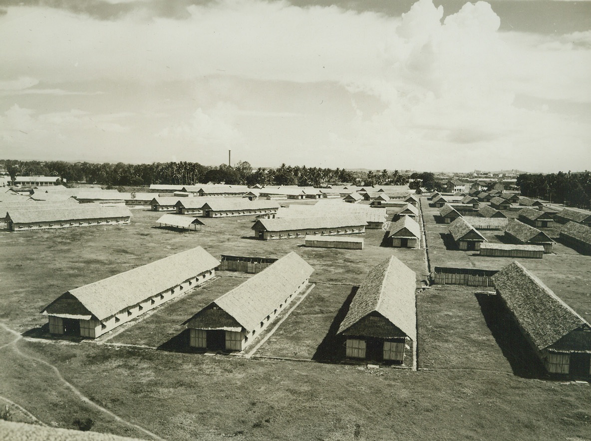 SINGAPORE CITIZENS READY FOR JAP BOMBERS, 12/16/41  SINGAPORE STRAITS SETTLEMENTS—A make shift evacuee village, one of several built inland near Singapore, to receive coastal citizens, when and if the Singapore Island is bombed by Japanese planes. Due to the fact that Nipponese troops have landed North of the island, in Malaya, this attack may come at any minute. Although these shelters are built of Bamboo and matting fibre, and are tinder to incendiary bombs, they are spaced far apart, so that if one is ignited, the others my be saved.Credit: ACME.;